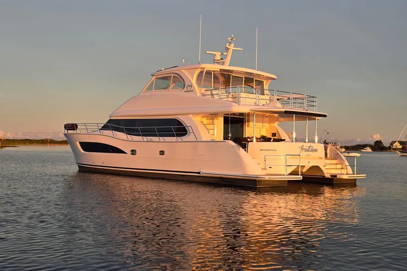 The Image of Luxurious 2020 Horizon PC60 yacht on calm water at sunset. - 0