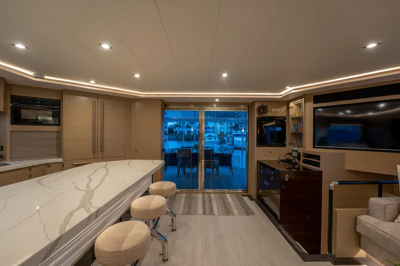 Slide: The Image of Luxurious interior of 2020 Horizon PC60 yacht with modern kitchen and seating area. - 14