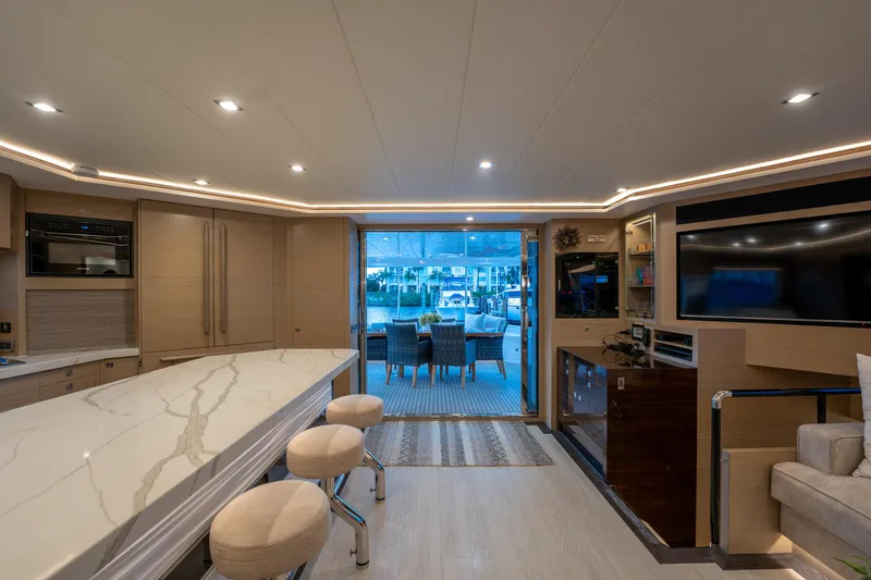 Slide: The Image of Luxurious interior of 2020 Horizon PC60 yacht with modern kitchen and seating area. - 15