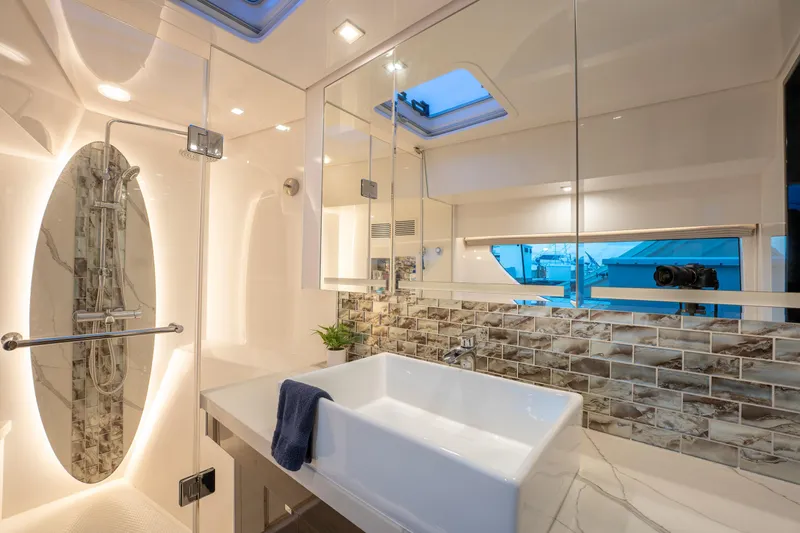 Slide: The Image of Luxurious yacht bathroom with modern fixtures, glass shower, and elegant tile backsplash. Horizon PC60, 2020. - 24