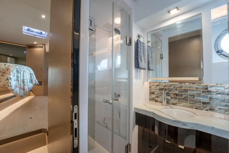 Slide: The Image of Luxurious Horizon PC60 2020 yacht bathroom with modern shower and elegant sink area. - 29