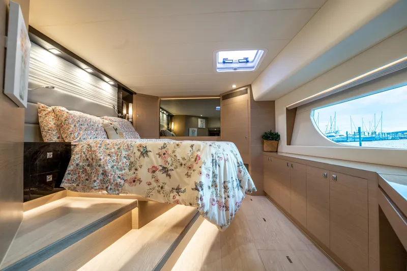 Slide: The Image of Luxurious bedroom interior of 2020 Horizon PC60 yacht with floral bedding and large window view. - 33