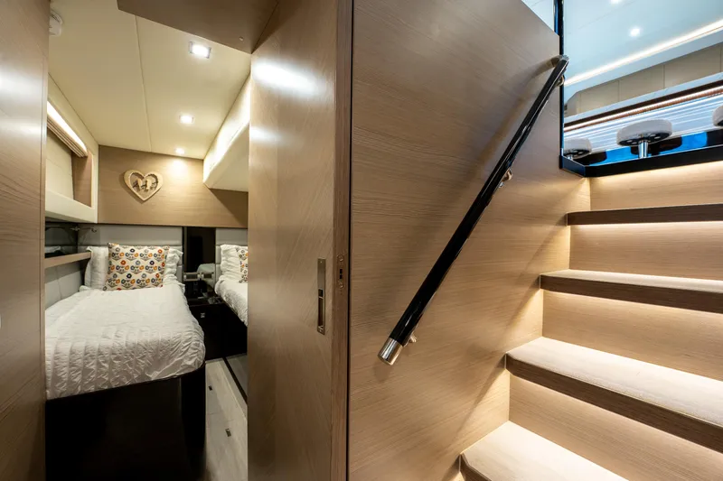 Slide: The Image of Luxurious interior of 2020 Horizon PC60 yacht with twin beds and wooden staircase. - 42