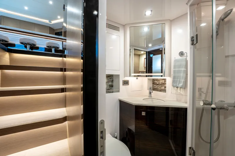 Slide: The Image of Luxurious Horizon PC60 yacht interior with modern bathroom and illuminated staircase, 2020 model. - 45