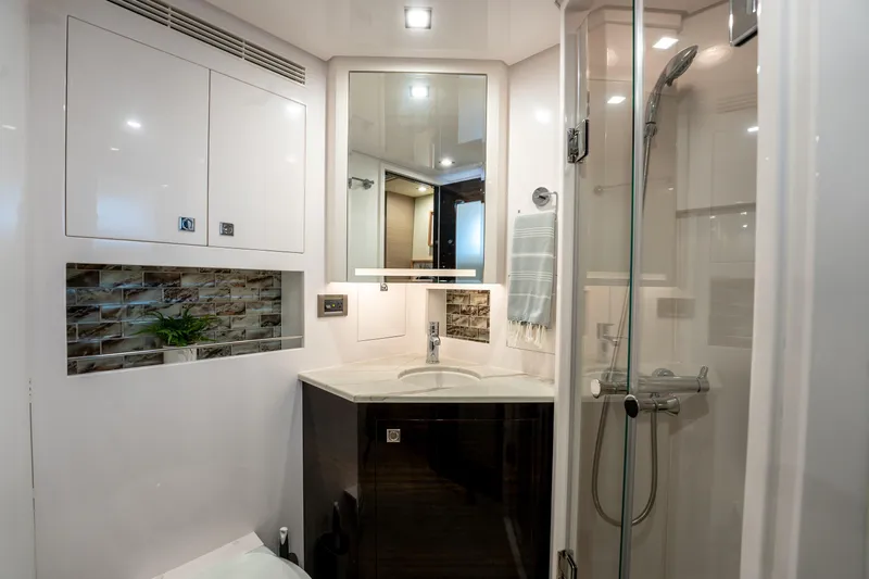 Slide: The Image of Luxurious bathroom in 2020 Horizon PC60 yacht with modern fixtures and glass shower. - 47