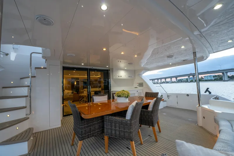 Slide: The Image of Luxurious Horizon PC60 yacht deck with dining area, wicker chairs, and elegant lighting, 2020 model. - 49
