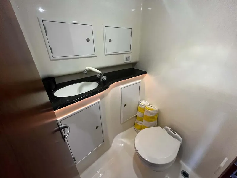 Slide: The Image of Scopinich 35 EXPRESS 2010 yacht bathroom with sink, toilet, and storage cabinets. - 15
