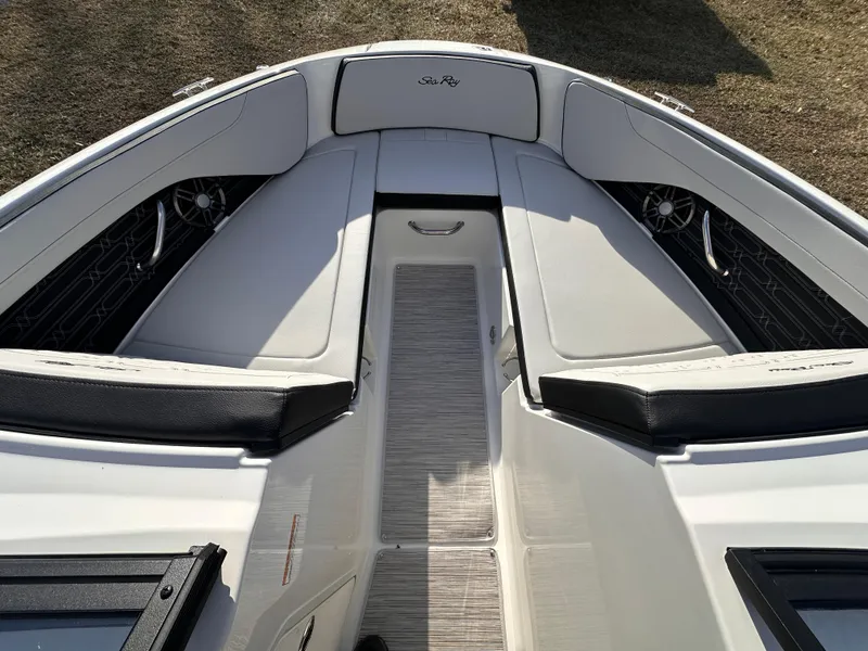 Slide: The Image of 2024 Sea Ray SPX 210 OB boat interior with white seating and sleek design. - 2