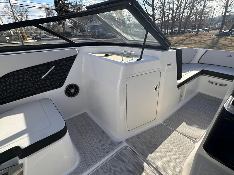 Slide: The Image of 2024 Sea Ray SPX 210 OB boat interior with seating and storage compartment. - 3