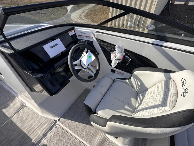 Slide: The Image of 2024 Sea Ray SPX 210 OB boat interior with steering wheel and dashboard, featuring modern design. - 4