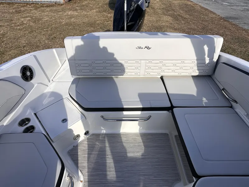 Slide: The Image of 2024 Sea Ray SPX 210 OB boat interior with cushioned seating and modern design. - 6
