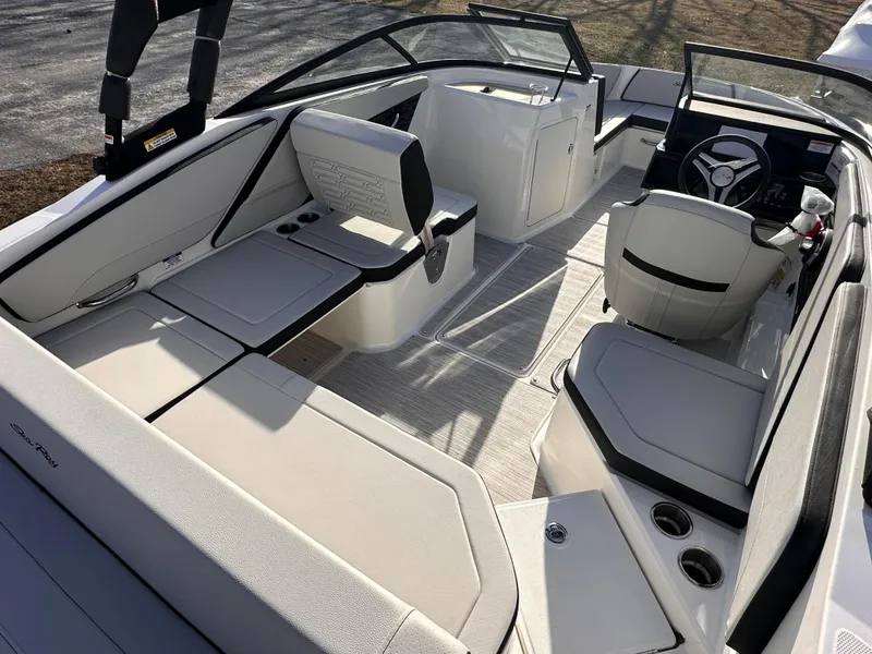 Slide: The Image of 2024 Sea Ray SPX 210 OB boat interior with modern seating and steering wheel. - 8