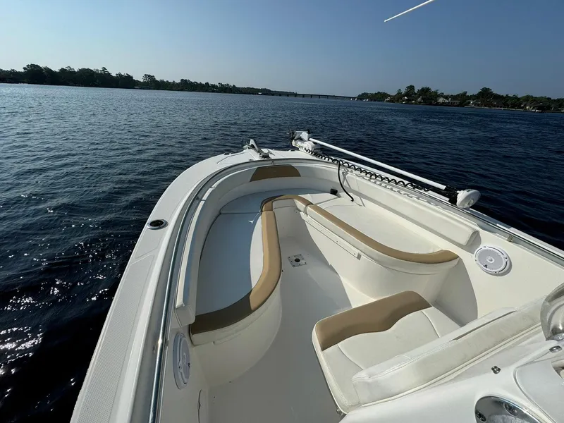 Slide: The Image of 2018 Edgewater 245CC boat on calm water, featuring spacious seating and sleek design. - 16