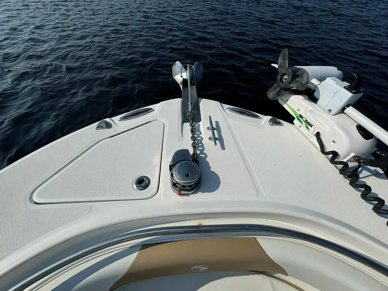 Slide: The Image of Bow of 2018 Edgewater 245CC boat with anchor and motor, on calm water. - 18