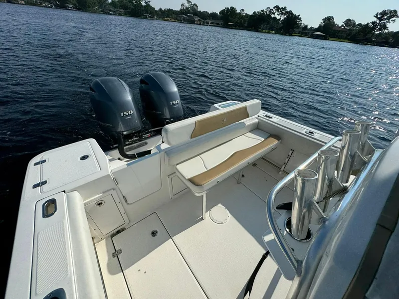 Slide: The Image of Edgewater 245CC 2018 boat with dual engines on a calm lake. - 23