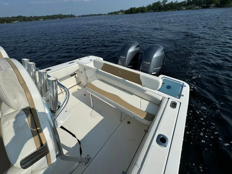 Slide: The Image of 2018 Edgewater 245CC boat with twin engines on a calm lake. - 24