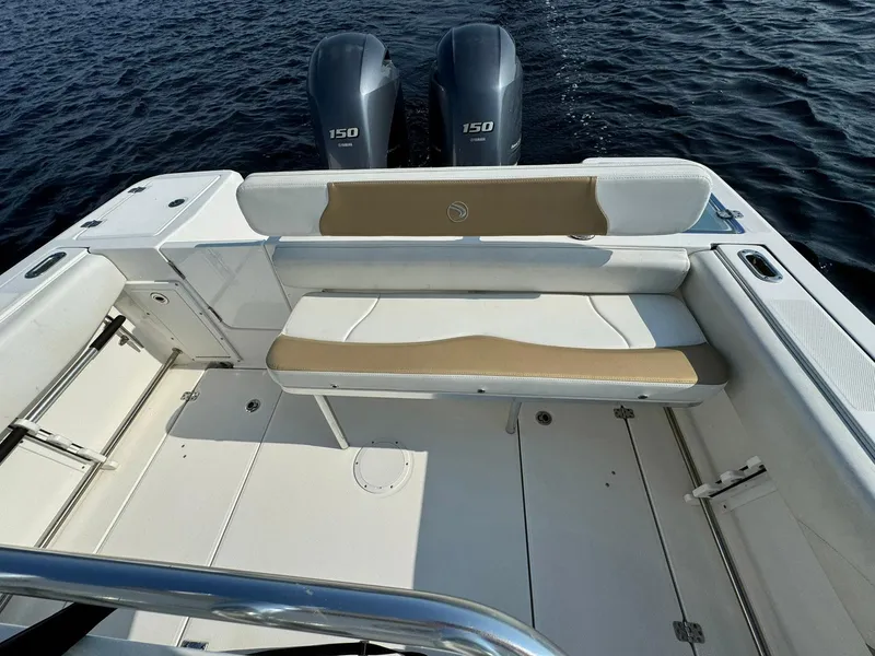 Slide: The Image of Edgewater 245CC 2018 boat interior with dual 150 engines on water. - 25