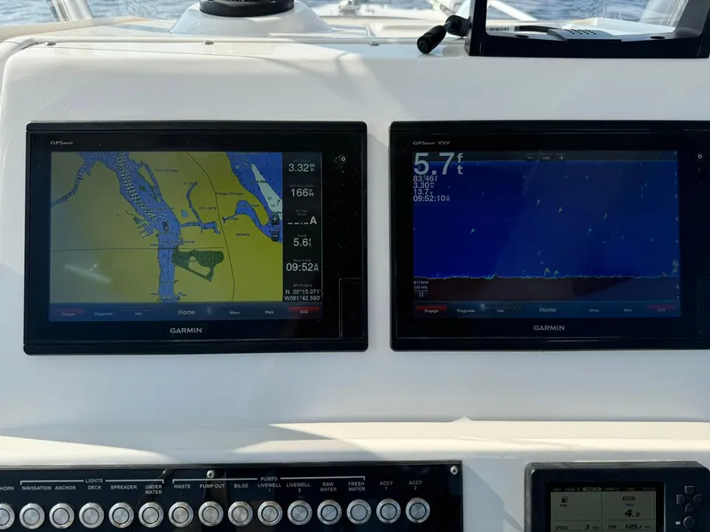 Slide: The Image of Edgewater 245CC 2018 boat dashboard with dual Garmin navigation displays. - 28