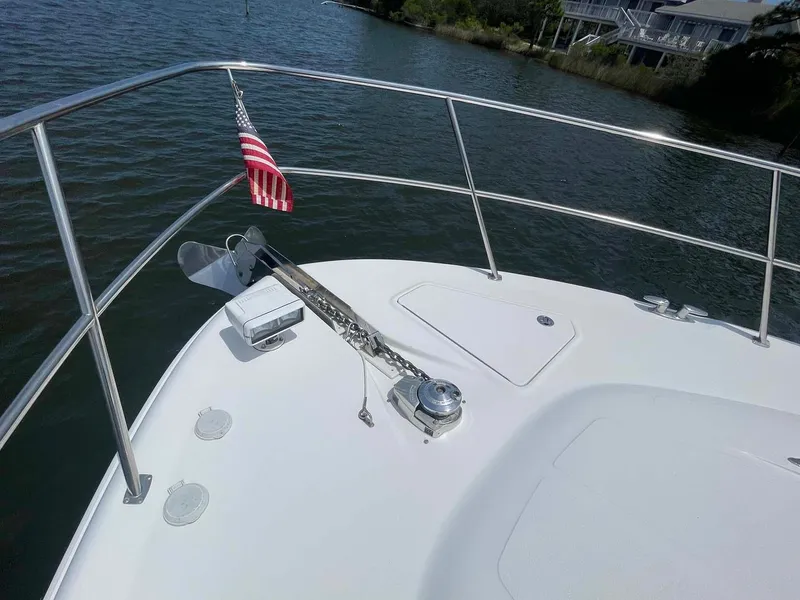 Slide: The Image of 2003 Sea Ray 560 Sedan Bridge bow with anchor and American flag. - 20