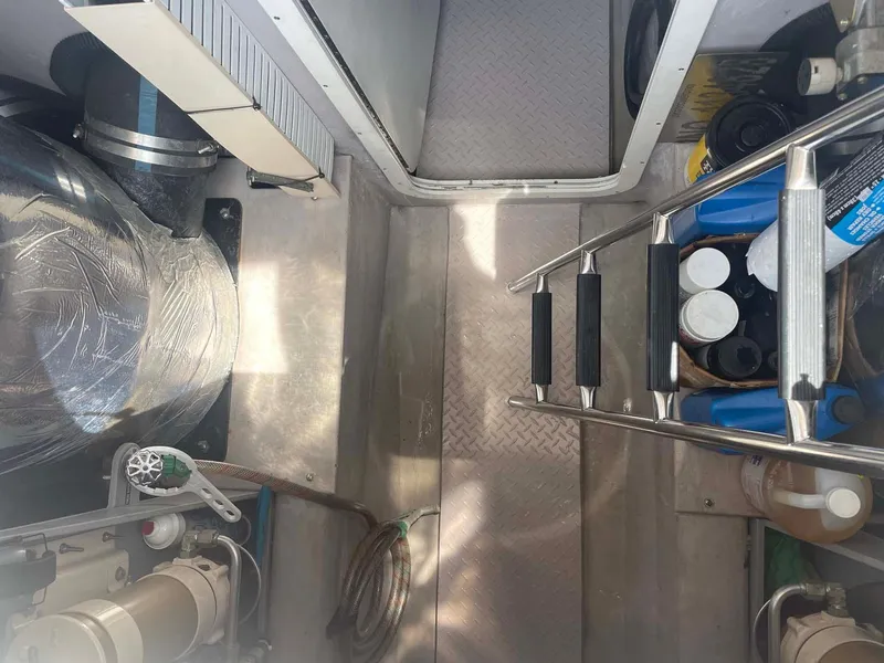 Slide: The Image of Engine room of 2003 Sea Ray 560 Sedan Bridge with equipment and storage. - 38