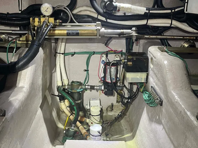 Slide: The Image of Engine compartment of a 2003 Sea Ray 560 Sedan Bridge, showcasing mechanical components and wiring. - 42