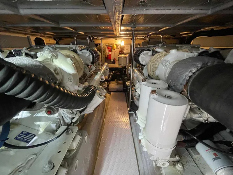 Slide: The Image of Engine room of a 2003 Sea Ray 560 Sedan Bridge yacht, showcasing dual engines and mechanical components. - 44