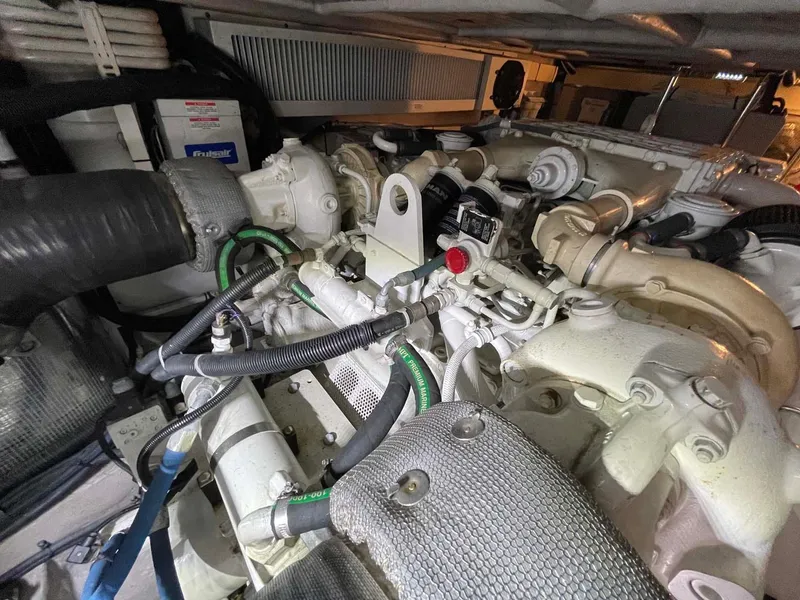 Slide: The Image of Engine compartment of a 2003 Sea Ray 560 Sedan Bridge yacht, showcasing mechanical components. - 45