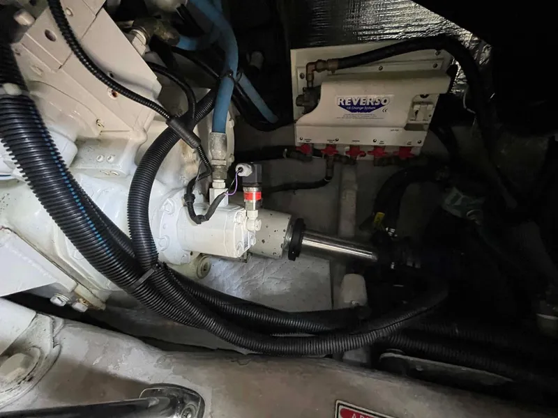 Slide: The Image of Engine compartment of a 2003 Sea Ray 560 Sedan Bridge with visible mechanical components. - 49