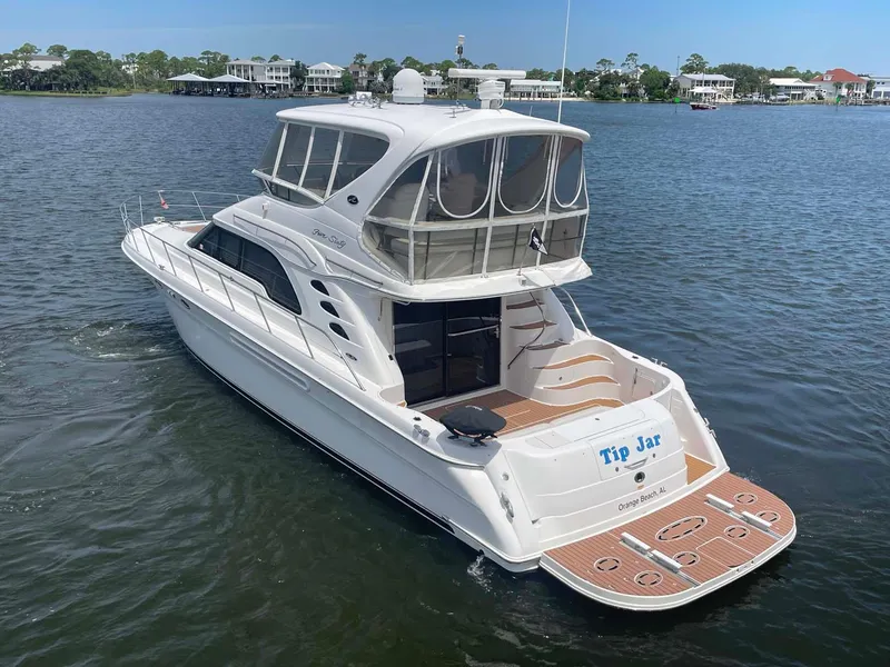 Slide: The Image of 2003 Sea Ray 560 Sedan Bridge yacht on calm water, rear view. - 8