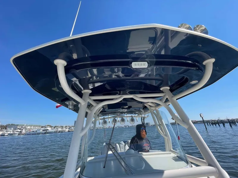 Slide: The Image of 2015 Hydra-Sports 3400 Center Console boat on water, featuring a sleek T-top design. - 18