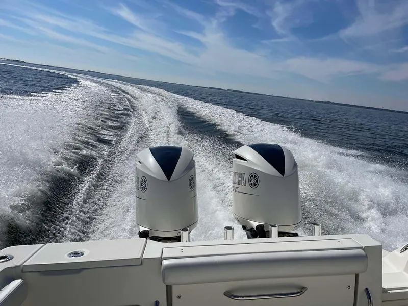Slide: The Image of 2015 Hydra-Sports 3400 Center Console boat cruising on open water, twin engines visible. - 31