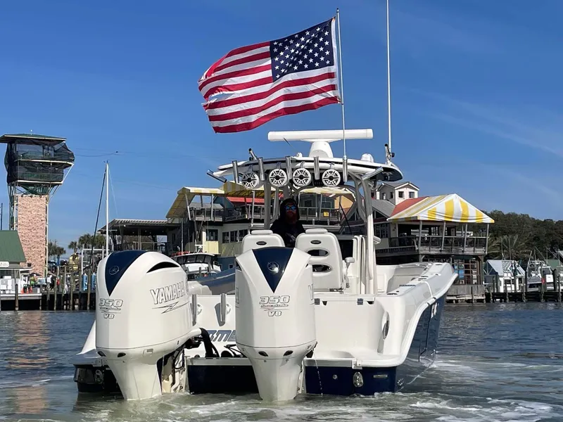 Slide: The Image of 2015 Hydra-Sports 3400 Center Console boat with dual Yamaha engines and American flag. - 36