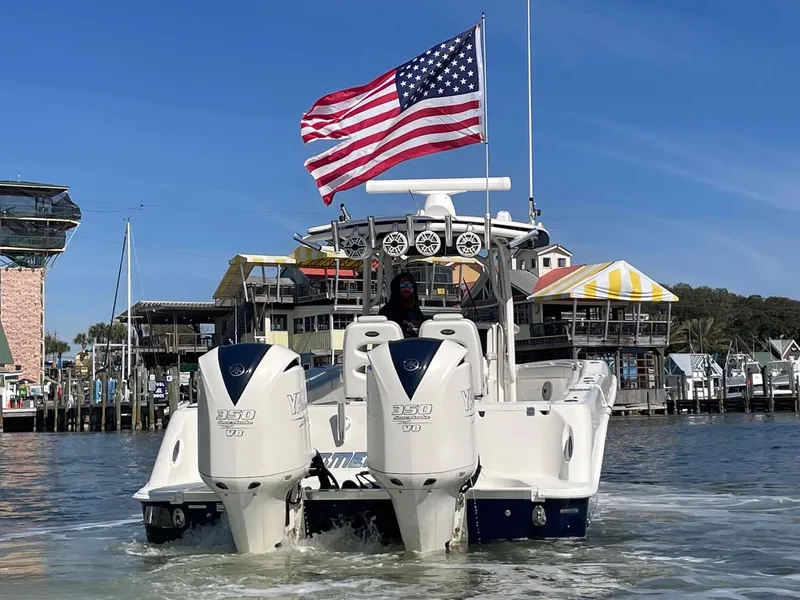 Slide: The Image of 2015 Hydra-Sports 3400 Center Console boat with American flag, docked in marina. - 37