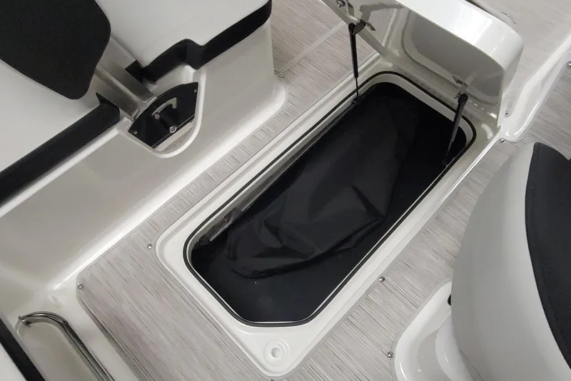Slide: The Image of 2025 Sea Ray SPX 190 OB boat storage compartment with open lid, showcasing interior space. - 6
