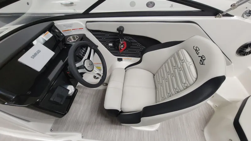 Slide: The Image of 2025 Sea Ray SPX 190 OB boat interior with steering wheel and branded seating. - 7
