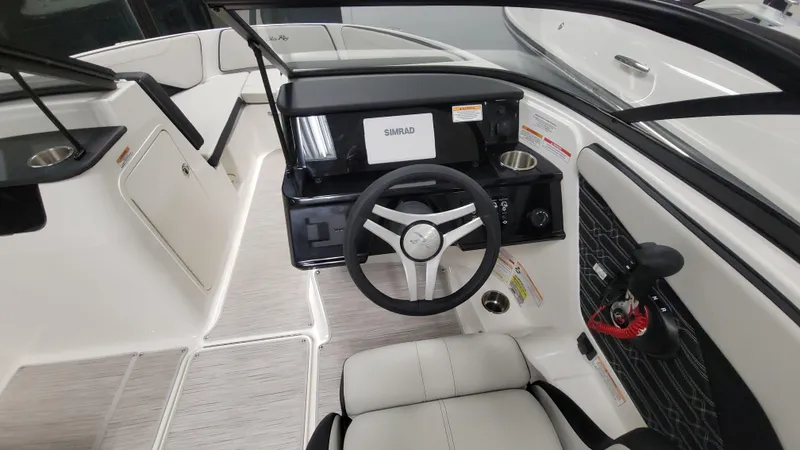 Slide: The Image of 2025 Sea Ray SPX 190 OB boat interior with steering wheel and dashboard. - 8