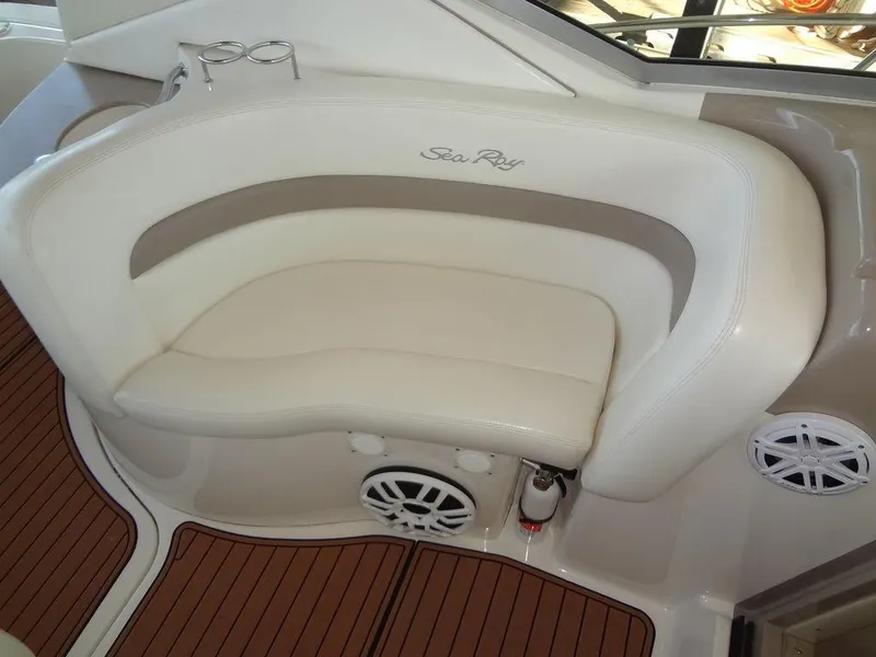Slide: The Image of 2005 Sea Ray 320 Sundancer boat interior with white seating and wood flooring. - 11