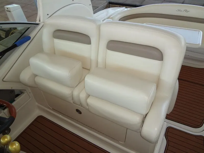 Slide: The Image of 2005 Sea Ray 320 Sundancer boat interior seating with white and beige upholstery. - 13