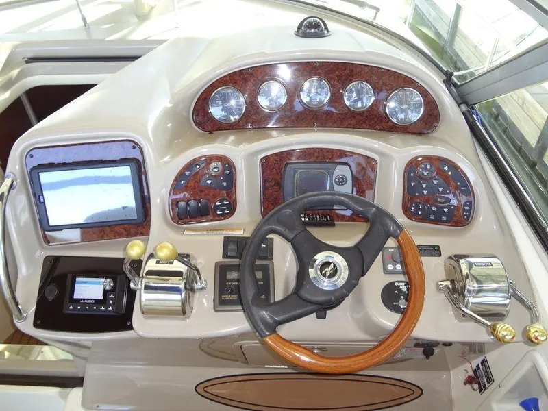 Slide: The Image of Helm of 2005 Sea Ray 320 Sundancer with wood accents and modern controls. - 15