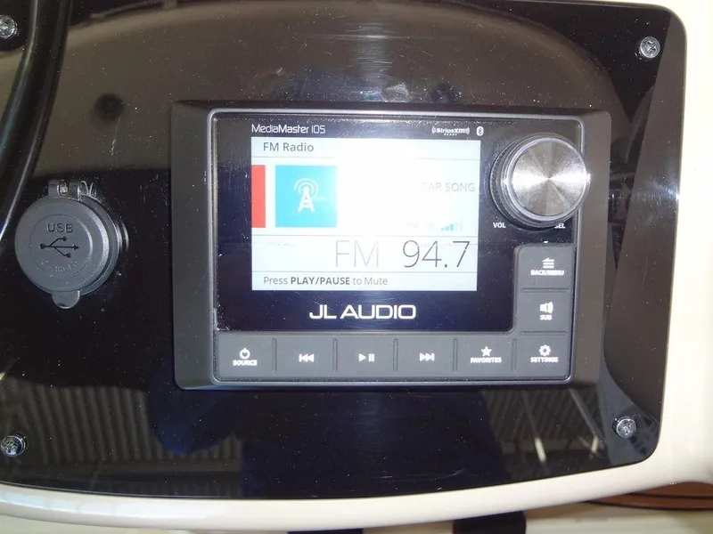 Slide: The Image of JL Audio MediaMaster display on 2005 Sea Ray 320 Sundancer, showing FM radio station 94.7. - 16