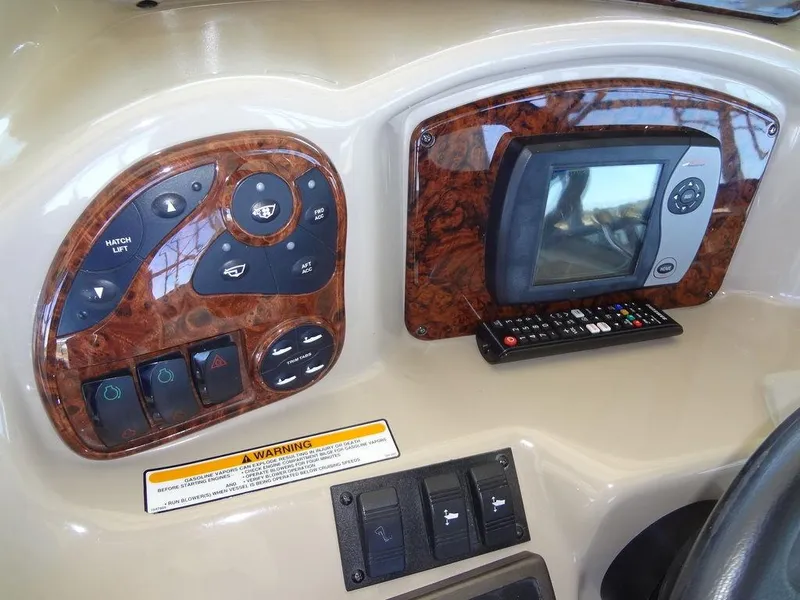 Slide: The Image of Control panel of 2005 Sea Ray 320 Sundancer boat with navigation system and switches. - 17