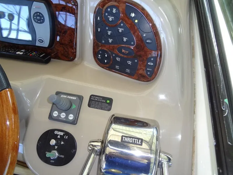 Slide: The Image of Control panel of a 2005 Sea Ray 320 Sundancer boat with throttle and navigation instruments. - 18