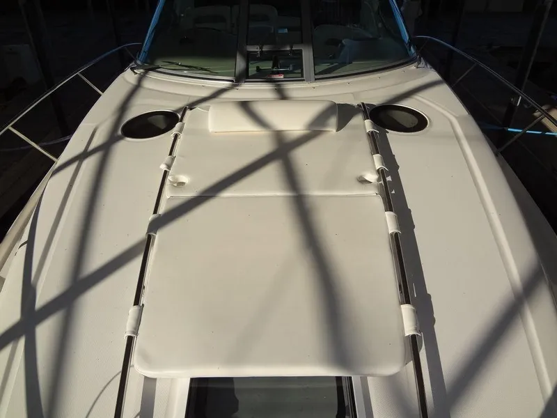 Slide: The Image of 2005 Sea Ray 320 Sundancer boat deck with sun pad and railings. - 23