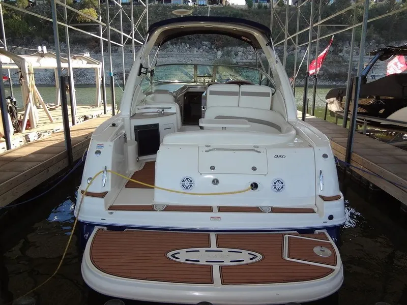 Slide: The Image of 2005 Sea Ray 320 Sundancer docked, showcasing spacious deck and seating area. - 3