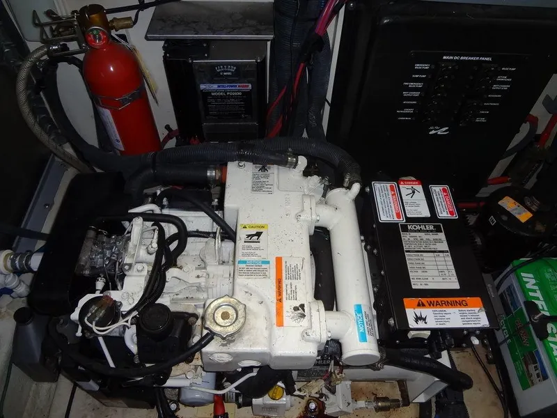 Slide: The Image of Engine compartment of a 2005 Sea Ray 320 Sundancer with visible fire extinguisher and control panel. - 42
