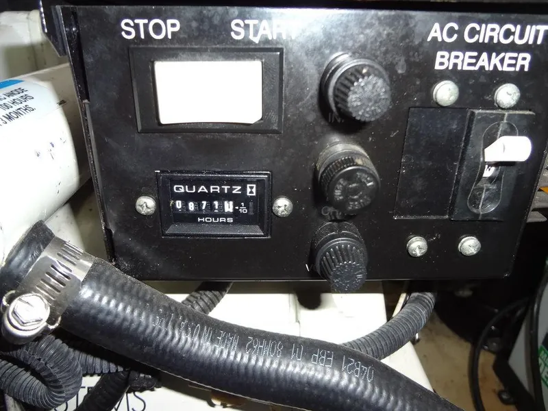 Slide: The Image of Control panel of a 2005 Sea Ray 320 Sundancer with hour meter and circuit breaker. - 43