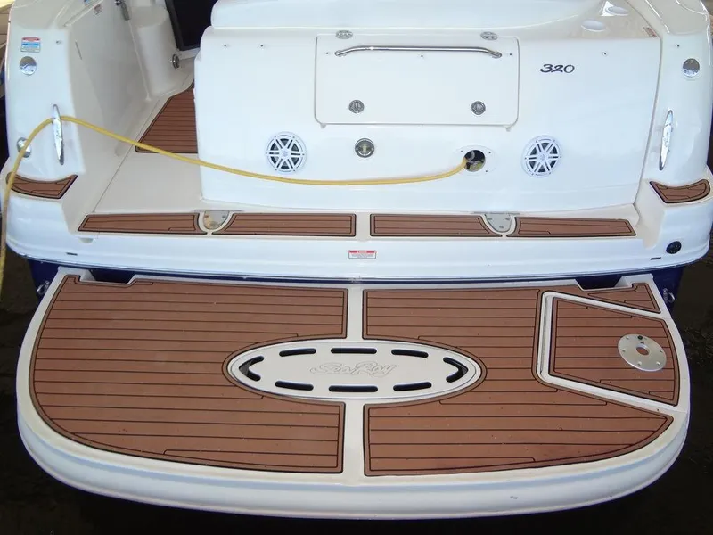 Slide: The Image of 2005 Sea Ray 320 Sundancer swim platform with teak decking and storage hatch. - 7