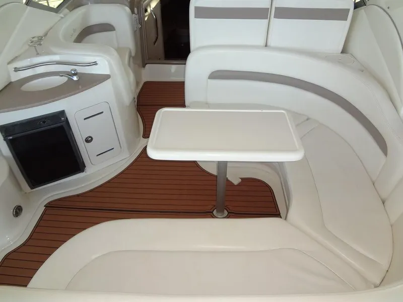 Slide: The Image of 2005 Sea Ray 320 Sundancer interior with white seating and wooden flooring. - 9
