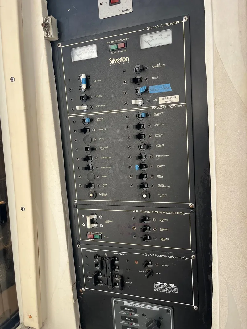Slide: The Image of Control panel of a 1993 Silverton 38 Express boat, featuring various switches and indicators. - 10