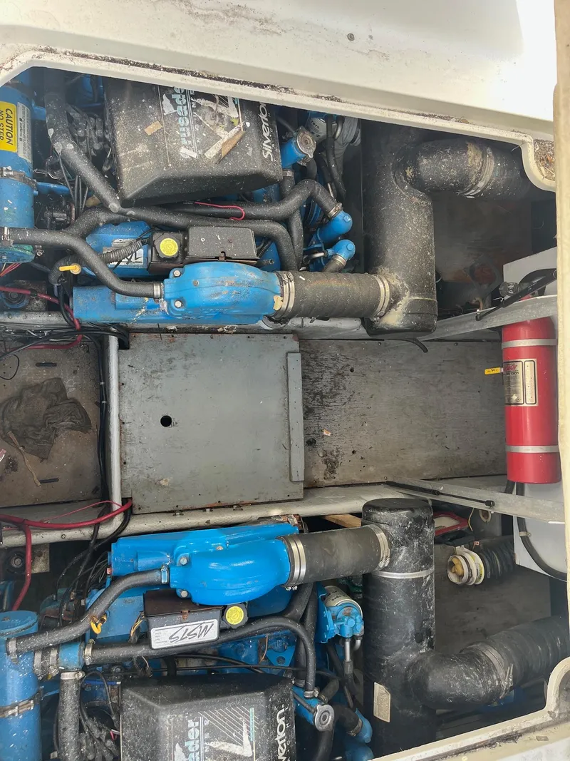 Slide: The Image of Engine compartment of a 1993 Silverton 38 Express boat, featuring dual engines and a fire extinguisher. - 14